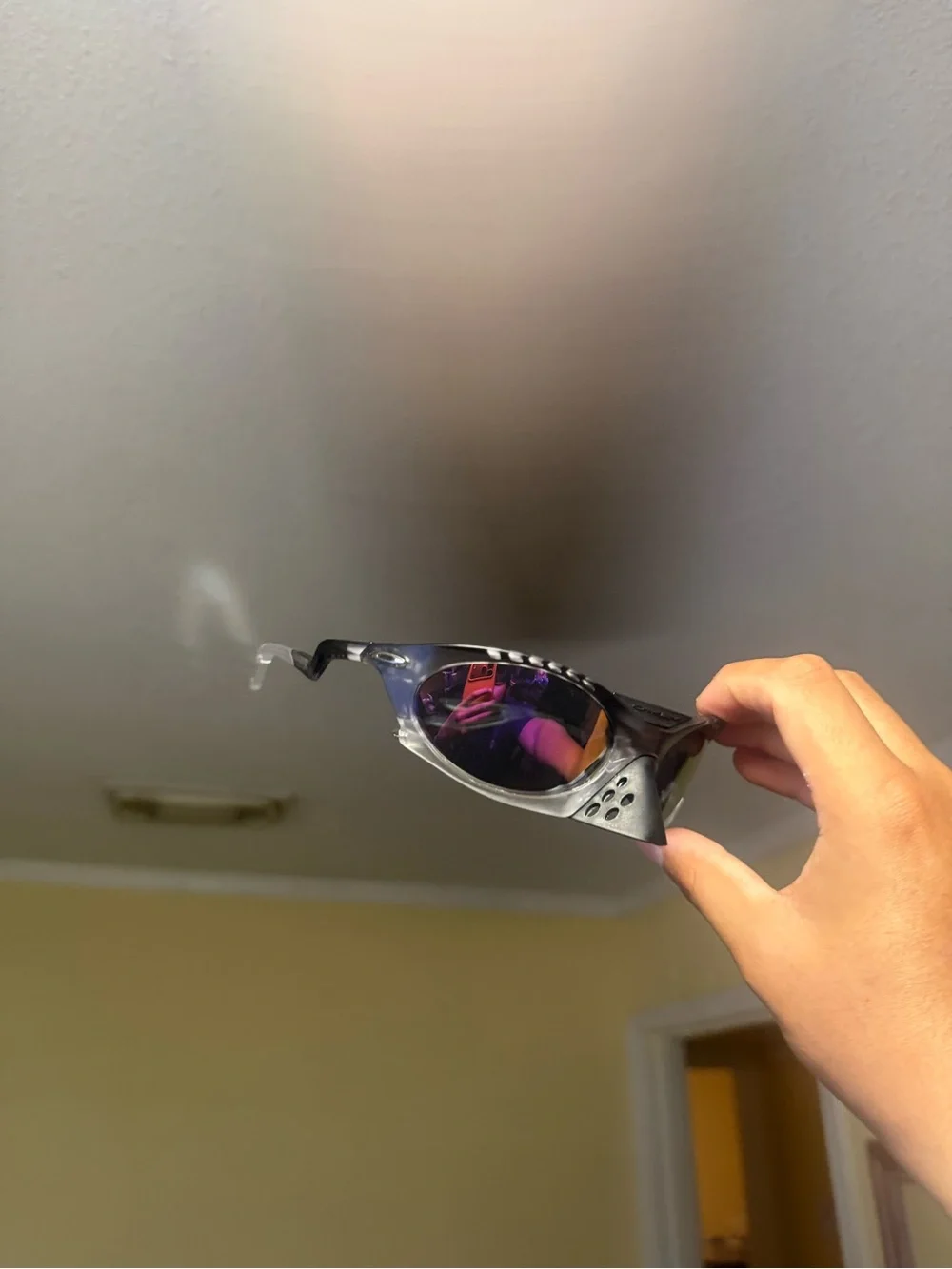 Sporty Black Sunglasses with Purple Mirrored Lenses Oakley